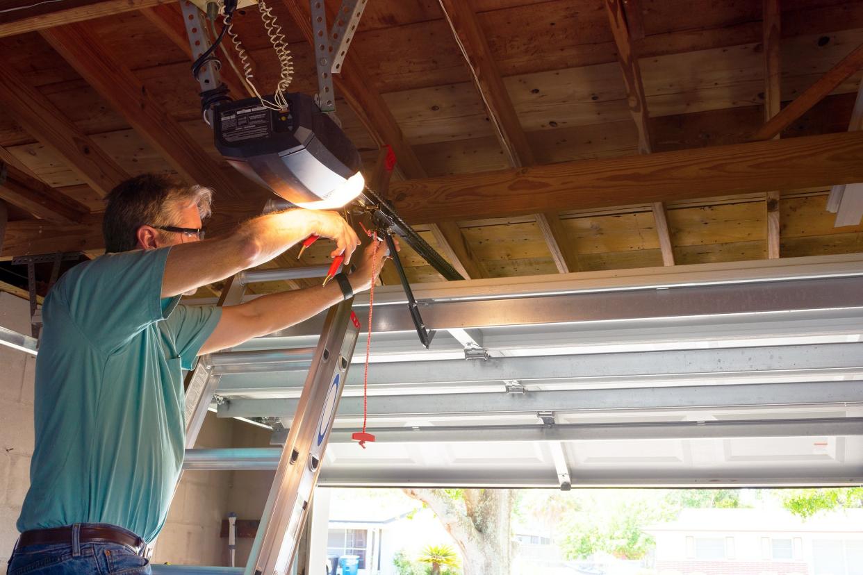 Man repairing an automatic garage door opener