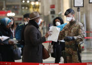 Police officers and soldiers check passengers leaving from Milan main train station, Italy, Monday, March 9, 2020. Italy took a page from China's playbook Sunday, attempting to lock down 16 million people — more than a quarter of its population — for nearly a month to halt the relentless march of the new coronavirus across Europe. Italian Premier Giuseppe Conte signed a quarantine decree early Sunday for the country's prosperous north. Areas under lockdown include Milan, Italy's financial hub and the main city in Lombardy, and Venice, the main city in the neighboring Veneto region. (AP Photo/Antonio Calanni)