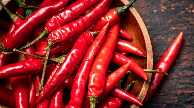 Top-down view of a bowl of fresh cayenne peppers