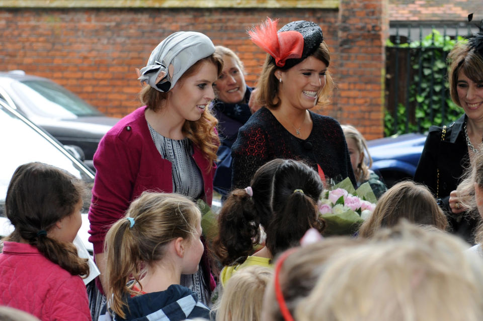 LONDON, ENGLAND - JUNE 03: Princess Beatrice (L) and Princess Eugenie (R) attend the 'Big Jubilee Lunch' at All Saints Church in Fulham ahead of the Diamond Jubilee River Pageant on June 3, 2012 in London, England. For only the second time in its history the UK celebrates the Diamond Jubilee of a monarch. Her Majesty Queen Elizabeth II celebrates the 60th anniversary of her ascension to the throne. Thousands of well-wishers from around the world have flocked to London to witness the spectacle of the weekend's celebrations. The Queen along with all members of the royal family will participate in a River Pageant with a flotilla of a 1,000 boats accompanying them down The Thames. (Photo by Matt Grayson - WPA Pool/Getty Images)