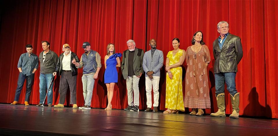 The cast of "Chocolate Lizards" listens as director Mark Bristol talks briefly about the movie after is showed Wednesday night at the Paramount Theatre. At the right are stars Thomas Haden Church and Carrie-Anne Moss, to his right. Third from the left as Bruce Dern, who was assisted to the theater stage.