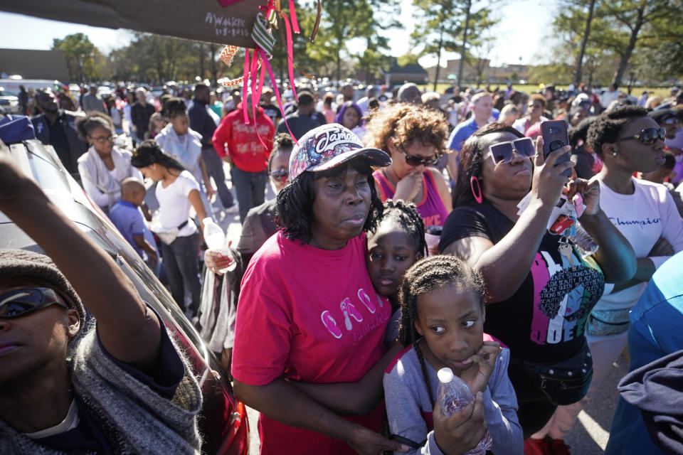 People attend a community rally outside Walmart, Saturday, Jan. 5, 2019, in Houston for seven-year-old Jazmine Barnes, who was killed on Sunday. Jazmine was shot to death nearby while riding in a car with her mother and three sisters. (Melissa Phillip/Houston Chronicle via AP)