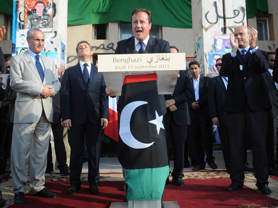 BENGHAZI, LIBYA - SEPTEMBER 15:  Prime Minister David Cameron (C) addresses the crowds in Victory Square, as French President Nicholas Sarkozy (Center L) looks on, September 15, 2011 in Benghazi, Libya. Cameron and Sarkozy are the first leaders from countries involved in the NATO-led military operations against Muammar Gaddafi to visit the freed capital. The pair met with NTC leaders and gave a press conference.  (Photo by Stefan Rousseau - Pool/Getty Images)