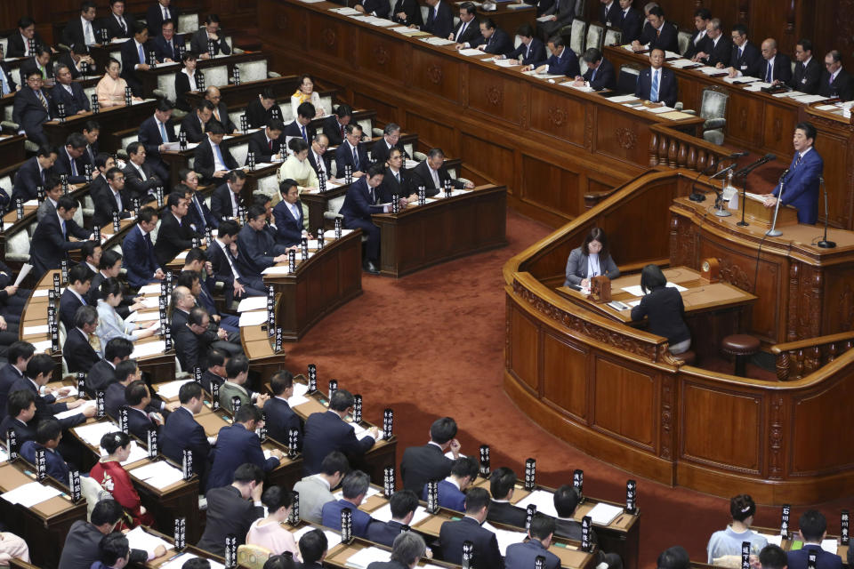 Japanese Prime Minister Shinzo Abe, top right, delivers a policy speech in Tokyo, Monday, Jan. 20, 2020. Abe said Monday that Japan will form a space defense unit to protect itself from potential threats as rivals develop missiles and other technology and the new unit will work closely with its American counterpart recently launched by President Donald Trump. (AP Photo/Koji Sasahara)