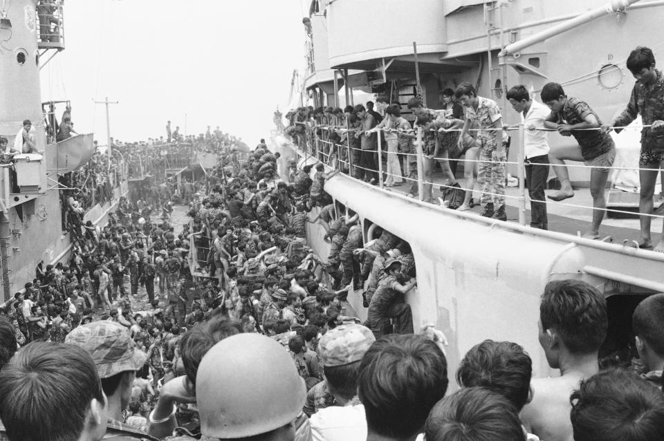 FILE - South Vietnamese Marines leap in panic aboard a cutter from an LST in Danang Harbor in Da Nang, Vietnam, April 1, 1975 as they are evacuated from the city, shortly before its fall to the Viet Cong and North Vietnamese. Cutters in turn hauled them south to Cam Ranh Bay. The Immigration and Nationality Act of 1952 lets the president grant entry for humanitarian reasons and matters of public interest. Previous administrations have admitted large numbers of Hungarians, Vietnamese and Cubans. (AP Photo, File)