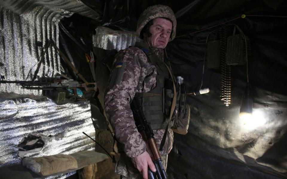 A Ukrainian Military Forces serviceman, looks on in a dugout on the frontline with Russia-backed separatists  - ANATOLII STEPANOV/AFP