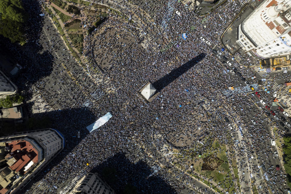 Argentine soccer fans descend on the capital's Obelisk to celebrate their team's World Cup victory over France, in Buenos Aires, Argentina, Sunday, Dec. 18, 2022. (AP Photo/Rodrigo Abd)