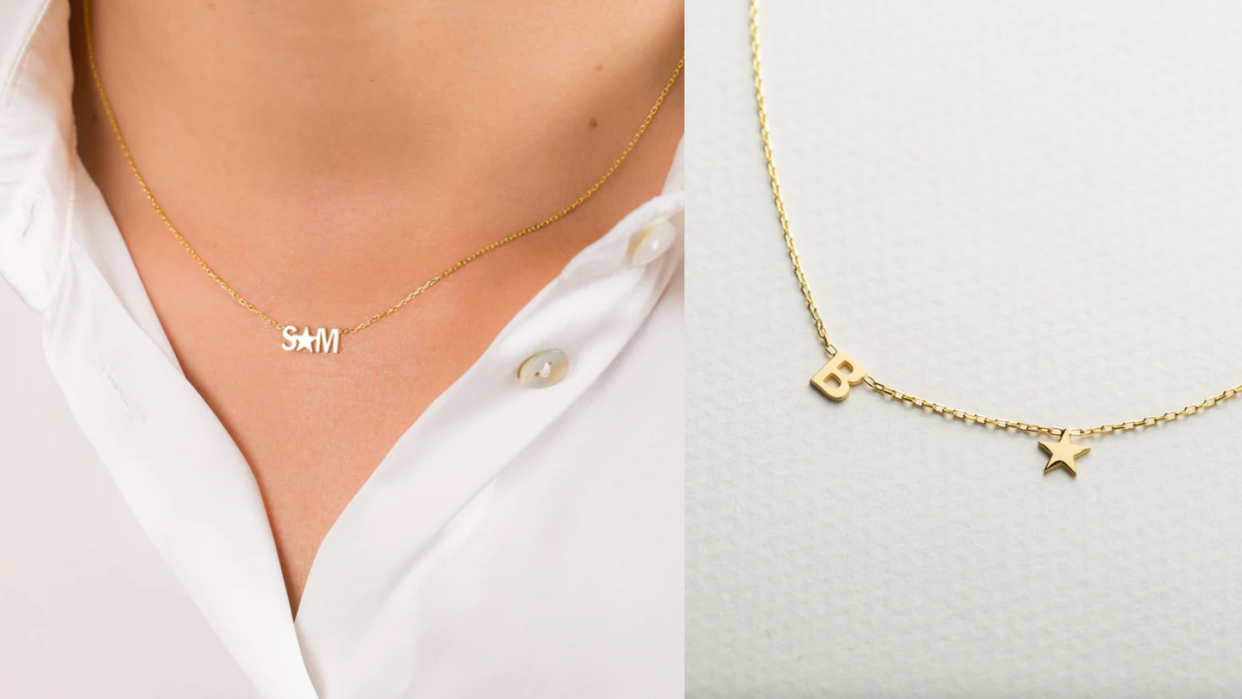 a person's chest with a gold necklace on it that has an s charm a star charm and an m charm in the middle