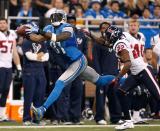 Calvin Johnson #81 of the Detroit Lions makes a second quarter catch in front of Alan Ball #22 of the Houston Texans at Ford Field on November 22, 2012 in Detroit, Michigan. (Photo by Gregory Shamus/Getty Images)