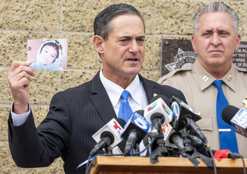 Orange County District Attorney Todd Spitzer holds up a photo of Aiden Leos during a news conference outside the CHP office in Santa Ana, Calif. on Monday, June 7, 2021 to update on the investigation into the shooting death of 6-year-old Aiden Leos. Officials should detail how they tied two suspects, a boyfriend and girlfriend from Costa Mesa, to the shooting. Marcus Anthony Eriz, 24, and Wynne Lee, 23, were arrested Sunday, June 6. (Leonard Ortiz/The Orange County Register via AP)