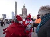A child in a red costume collects money for Poland's most popular nationwide fundraiser for health purposes, the Great Orchestra of Christmas Charity, that was postponed by two weeks due to the pandemic, in downtown Warsaw, Poland, on Sunday, Jan. 31, 2021. Anti-government protesters angry about a near-total abortion ban suspended their marches for the weekend to show solidarity and ensure that they didn't steal the spotlight from the event. (AP Photo/Czarek Sokolowski)