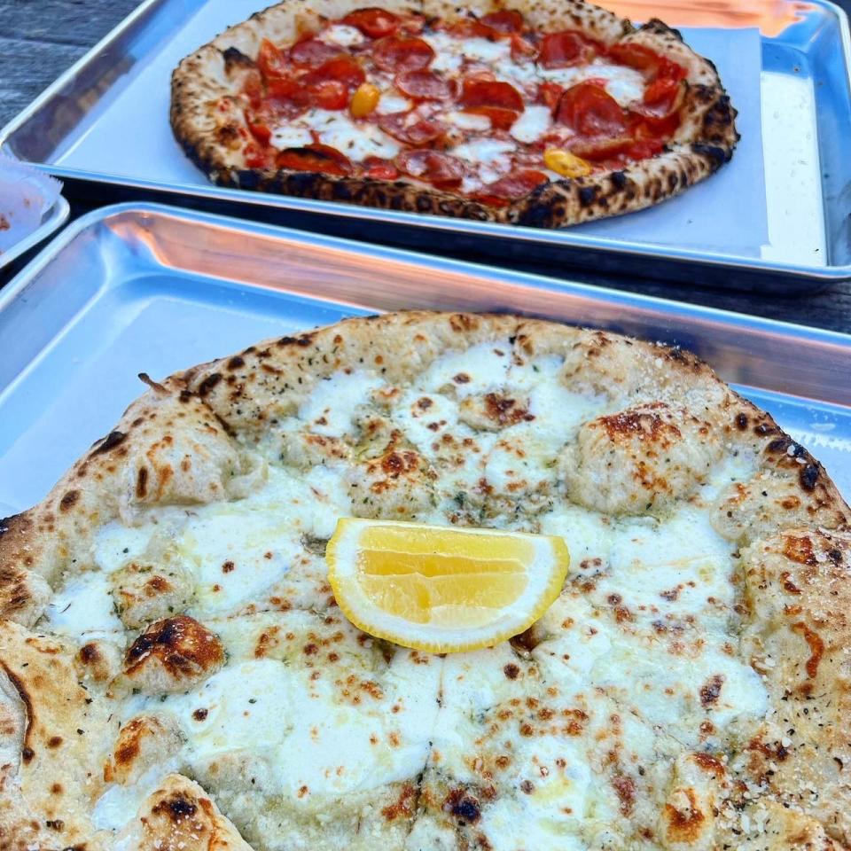 Pie95 serves wood-fired pizzas that take less than three minutes to cook. The crust is light and chewy, with a hint of char around the edges.