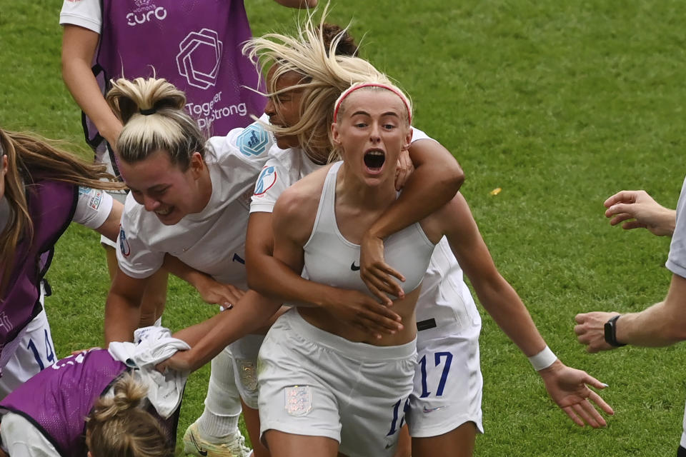 England's Chloe Kelly, centre, celebrates with teammates after scoring her side's second goal during the Women's Euro 2022 final soccer match between England and Germany at Wembley stadium in London, Sunday, July 31, 2022. (AP Photo/Rui Vieira)