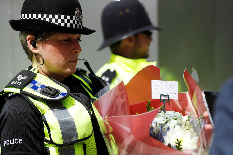 Police officer carrying flowers