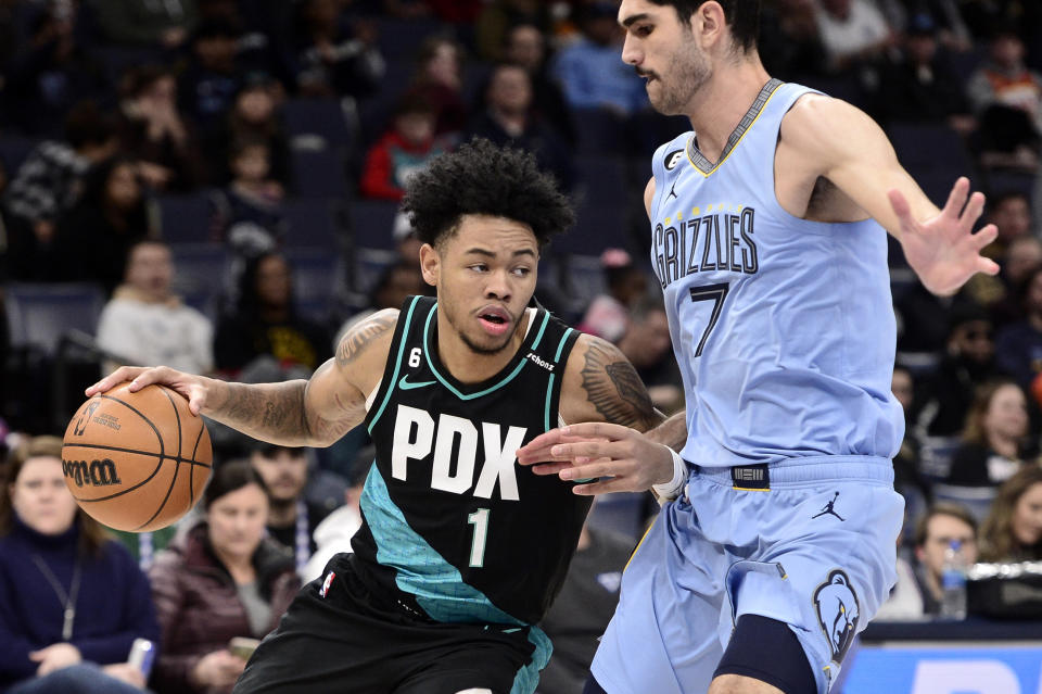 Portland Trail Blazers guard Anfernee Simons (1) handles the ball against Memphis Grizzlies forward Santi Aldama (7) in the first half of an NBA basketball game Wednesday, Feb. 1, 2023, in Memphis, Tenn. (AP Photo/Brandon Dill)