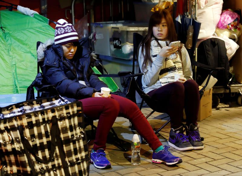 FILE PHOTO: Students Prince Wong and Isabella Lo, who are on a hunger strike, sit in a tent outside the government headquarters in Hong Kong