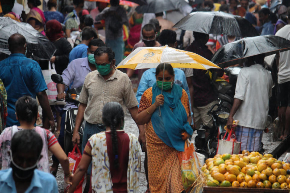 Shoppers crowd a street during heavy rains in Mumbai on June 3. Source: Getty