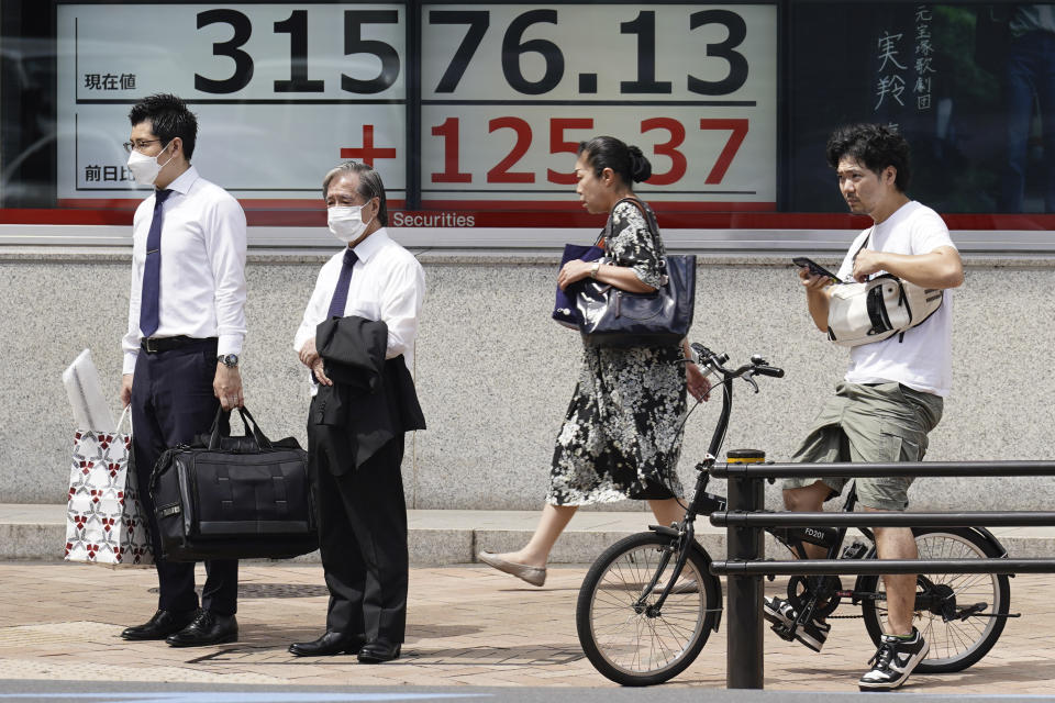 People stand in front of an electronic stock board showing Japan's Nikkei 225 index at a securities firm Monday, Aug. 21, 2023, in Tokyo. Asian stocks were mixed Monday as traders looked ahead to the Federal Reserve’s summer conference for signs of whether the U.S. central bank thinks inflation is under control or more interest rate hikes are needed to cool inflation. (AP Photo/Eugene Hoshiko)