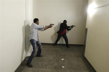 Armed police search Westgate Shopping Centre in Nairobi, September 21, 2013. REUTERS/Goran Tomasevic