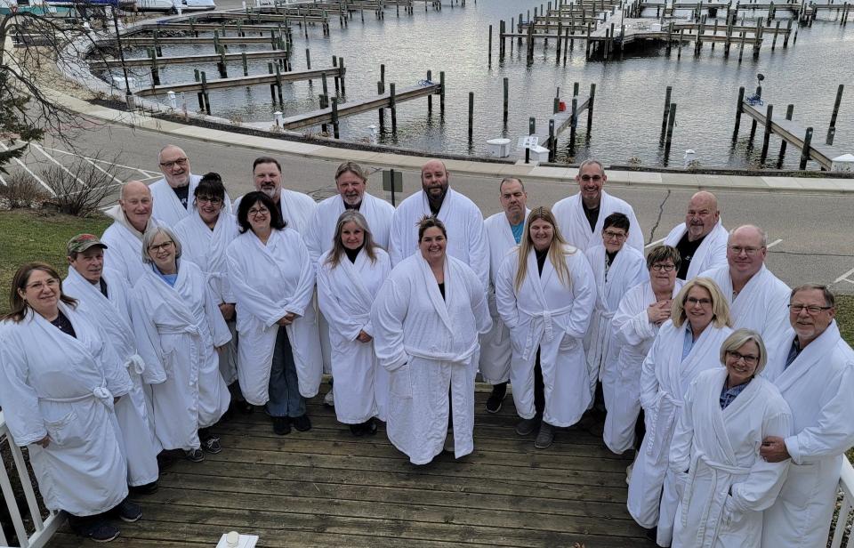 Members of the Toledo Sail and Power Squadron are shown at the recent Winter Rendezvous. A tradition at the Carriage House is to take group photos of guests wearing the robes provided by the bed and breakfast.