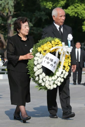 Representatives of atomic bomb survivors offer a wreath at the 73rd anniversary memorial service