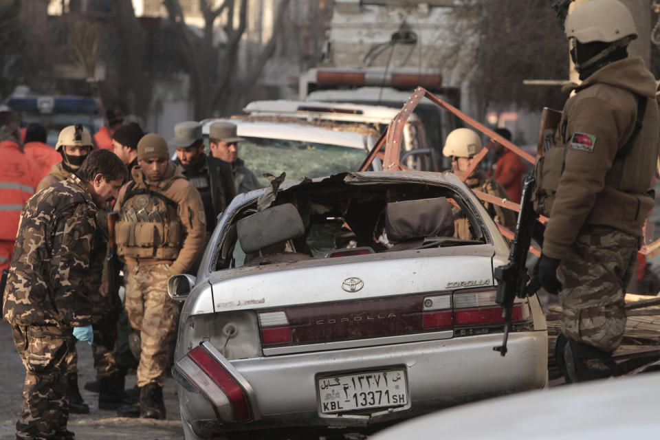 Afghan security forces investigate the aftermath of Friday's suicide attack and shooting in Kabul, Afghanistan, Saturday, Jan. 18, 2014. A suicide bomber blew himself up outside a Kabul restaurant filled with foreigners and affluent Afghans, while two gunmen snuck in through the back door and opened fire Friday in a brazen dinnertime attack that killed 16 people, officials said. (AP Photo/Rahmat Gul)