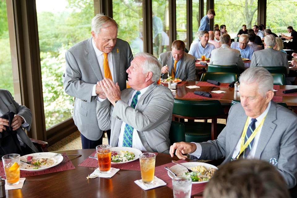 Jun 5, 2024; Columbus, Ohio, USA; Jack Nicklaus shakes hands with Hale Irwin inside the clubhouse dining room during a practice day for the Memorial Tournament at Muirfield Village Golf Club.