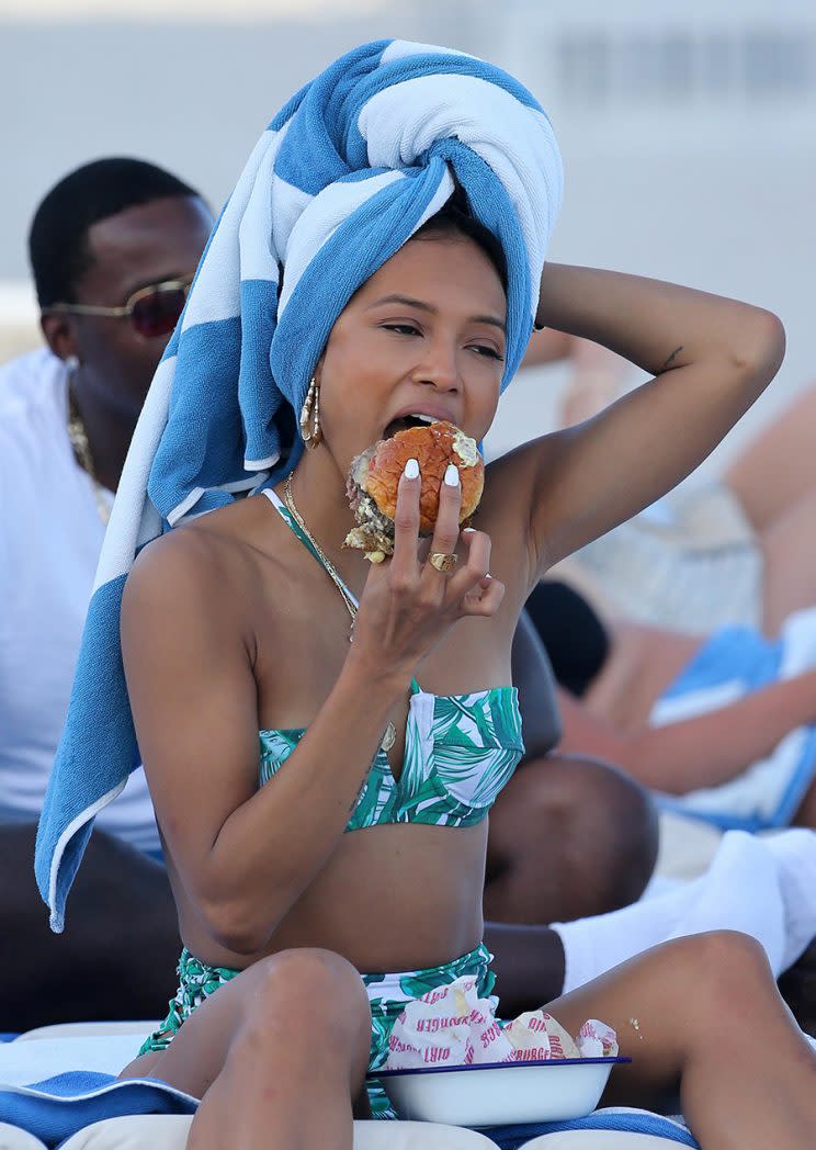 Karrueche Tran enjoying a burger on the beach. (Photo: INSTARimages)