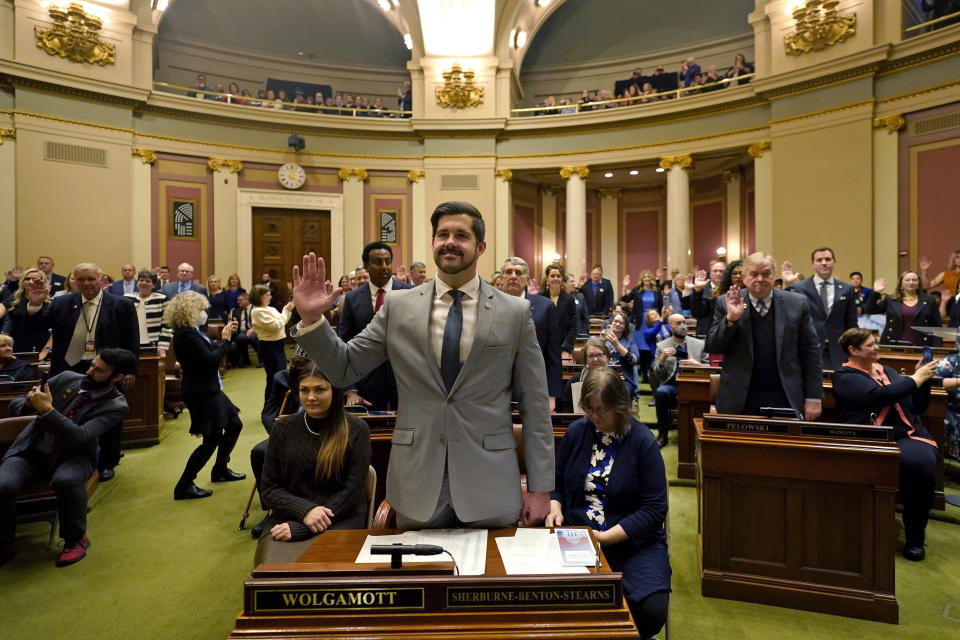 Dan Wolgamott, center, is sworn in to the Minnesota House of Representatives during the first day of the 2023 Legislative session, Tuesday, Jan. 3, 2023, in St. Paul, Minn. (AP Photo/Abbie Parr)