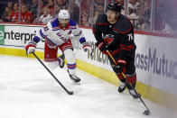 Carolina Hurricanes' Brady Skjei (76) protects the puck from New York Rangers' Barclay Goodrow (21) during the first period in Game 6 of an NHL hockey Stanley Cup second-round playoff series in Raleigh, N.C., Thursday, May 16, 2024. (AP Photo/Karl B DeBlaker)