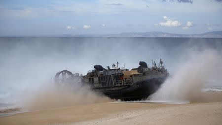 A NATO amphibious vehicle arrives to the seashore during a NATO military exercise at Raposa beach, near Setubal, Portugal October 20, 2015. REUTERS/Rafael Marchante