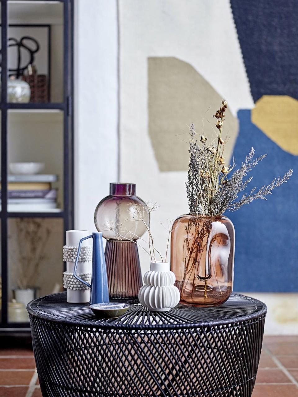 side table with a collection of vases