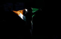 Gold medallist Katie Taylor of Ireland carries her country's flag during the presentation ceremony for the Women's Light (60kg) boxing competition at the London Olympic Games August 9, 2012. REUTERS/Damir Sagolj (BRITAIN - Tags: OLYMPICS SPORT BOXING TPX IMAGES OF THE DAY)