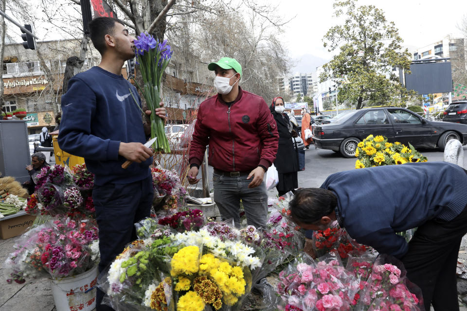 Flower sellers arrange their flowers ahead of the Persian New Year, or Nowruz, meaning "New Day." in northern Tajrish Square, Tehran, Iran, Monday, March 15, 2021. (AP Photo/Vahid Salemi)