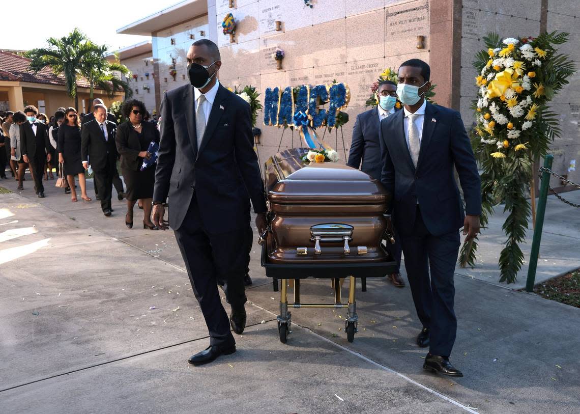 N. Patrick Range II, left, manager of Range Funeral Service, escorts the casket of Carrie P. Meek along with his staff while her family follows prior to being placed inside the burial vault at Caballero Rivero Dade North in Opa-locka, Florida on Dec. 7, 2021.