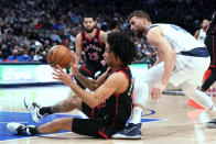 Toronto Raptors forward Justin Champagnie (11) comes up with a loose ball against Dallas Mavericks forward Maxi Kleber (42) during the first half of an NBA basketball game in Dallas, Wednesday, Jan. 19, 2022. (AP Photo/LM Otero)