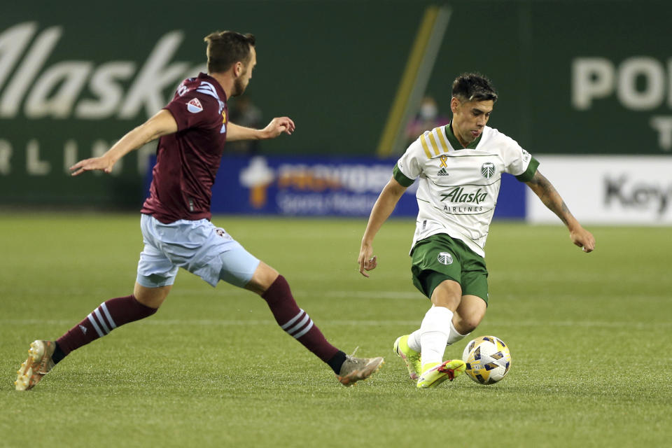 Portland Timbers forward Felipe Mora, right, navigates around a Colorado Rapids defender during an MLS soccer match, Wednesday, Sept. 15, 2021 in Portland, Ore. (Sean Meagher/The Oregonian via AP)