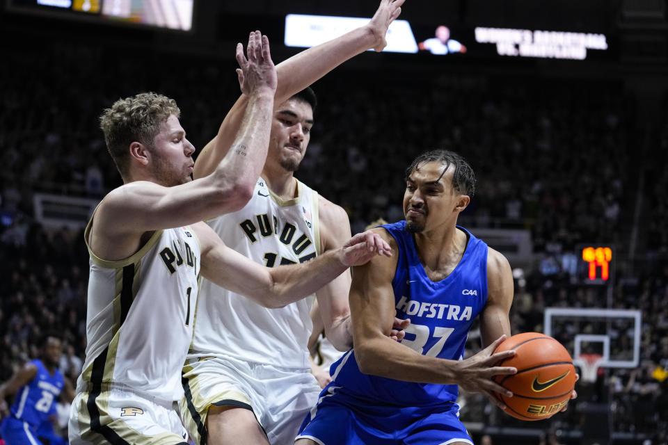 Hofstra forward Nelson Boachie-Yiadom (32) is stopped by Purdue forward Caleb Furst (1) and center Zach Edey (15) during the first half of an NCAA college basketball game in West Lafayette, Ind., Wednesday, Dec. 7, 2022. (AP Photo/Michael Conroy)
