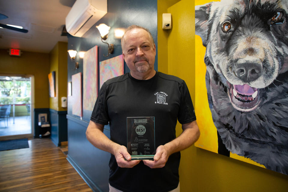 Kool Beanz Owner Keith Baxter holds the restaurant's 2020 Best of Tallahassee award Tuesday, June 1, 2021. 