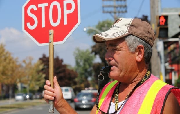 The Ottawa Safety Council hired 35 new crossing guards in recent weeks but they need more.   (Martin Trainor/CBC - image credit)