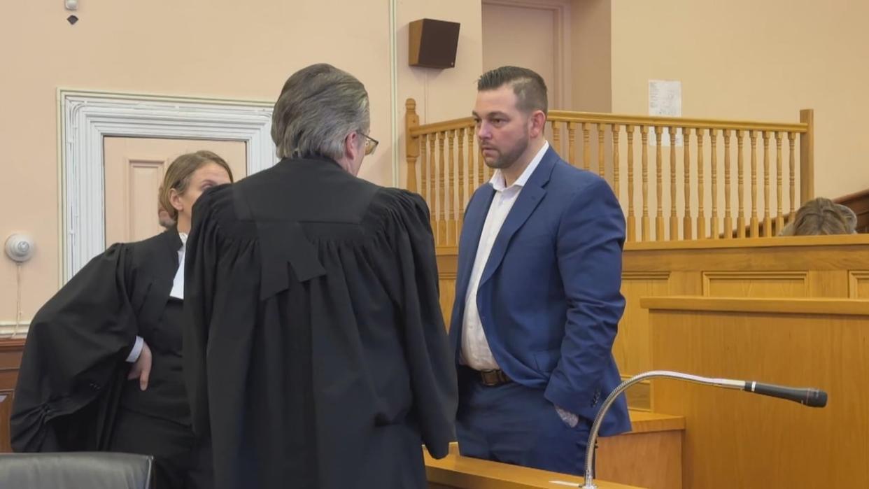 Craig Pope speaks with his lawyers, Mark Gruchy and Kathy Moulton, during closing submissions Thursday in St. John's. (Ryan Cooke/CBC - image credit)