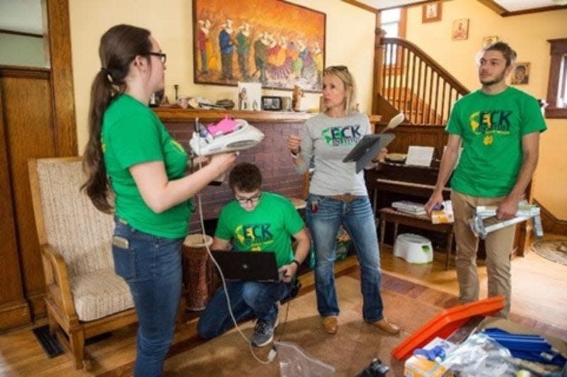 Heidi Beidinger (center, gray shirt) was part of a University of Notre Dame research team who tested homes in South Bend for lead, as shown in this file photo.