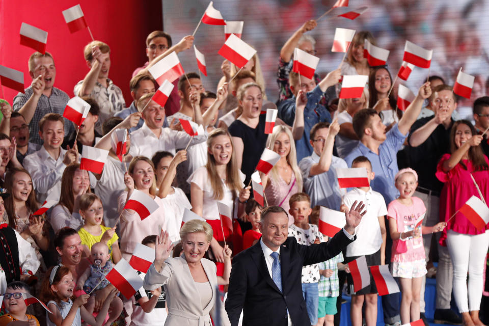 FILE - In this June 28, 2020, file photo, President Andrzej Duda and his wife Agata Kornhauser-Duda wave to supporters shortly after voting ended in the presidential election in Lowicz, Poland. Duda and Warsaw Mayor Rafal Trzaskowski are heading into a tight presidential runoff that is seen as an important test for populism in Europe. The Sunday, July 12 election comes after a bitter campaign that has exacerbated a conservative-liberal divide in the country. (AP Photo/Petr David Josek, File)