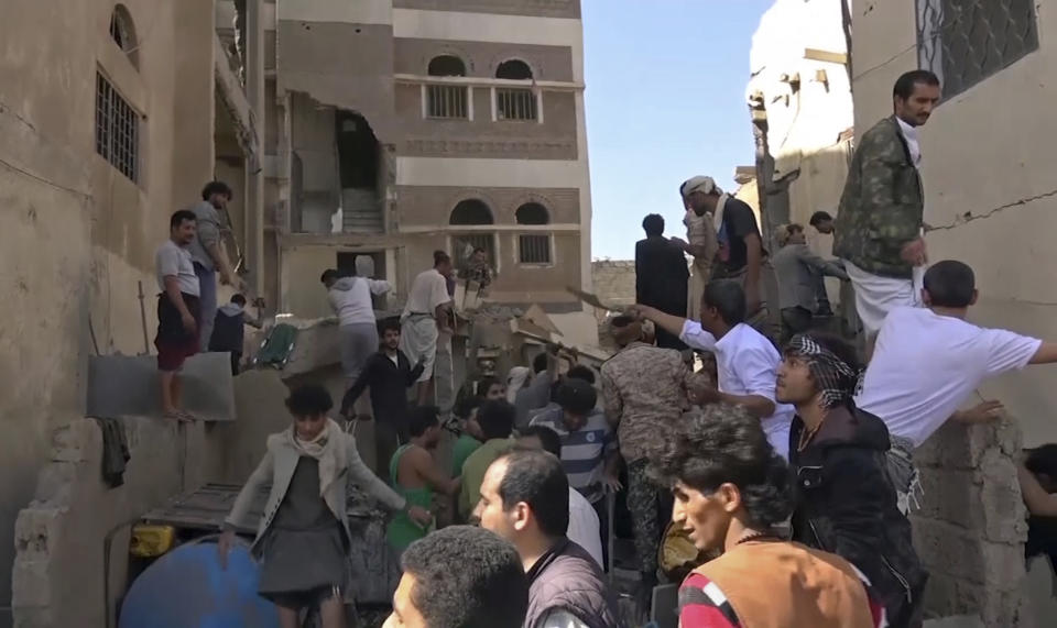 In this frame grab from from video, people search in the rubble following Saudi-led coalition airstrikes that killed at least six, including children, officials said, in the residential center of the capital, Sanaa, Yemen, Thursday, May 16, 2019. The Sanaa airstrikes came after Yemen's Iran-backed Houthi rebels, who control the capital, launched a drone attack earlier in the week on a critical oil pipeline in Saudi Arabia, Tehran's biggest rival in the region. (AP Photo)