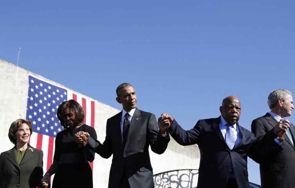 <div class="inline-image__caption"><p>Barack Obama and Michelle Obama hold hands with George W Bush, former first lady Laura Bush and Rep. John Lewis during commemoration of the 50th anniversary of the 'Bloody Sunday' historical civil rights march in 2015. </p></div> <div class="inline-image__credit">REUTERS</div>