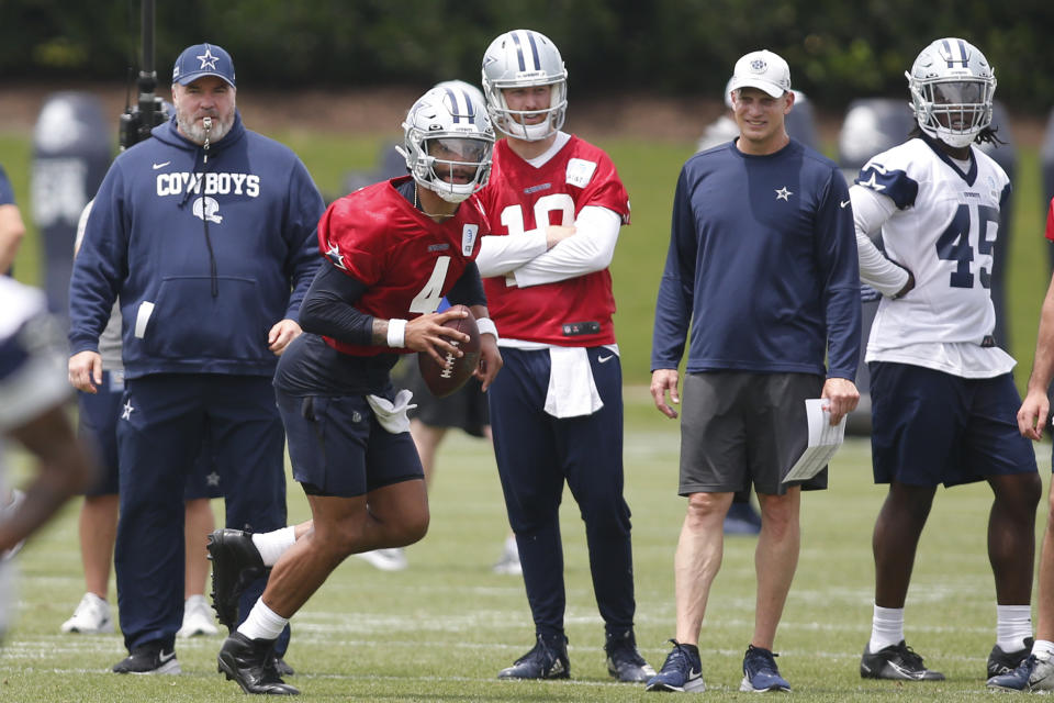 Jun 3, 2021; Frisco, TX, USA; Dallas Cowboys quarterback Dak Prescott (4) goes through drills as head coach Mike McCarthy watches during voluntary Organized Team Activities at the Star Training Facility in Frisco, Texas. Mandatory Credit: Tim Heitman-USA TODAY Sports