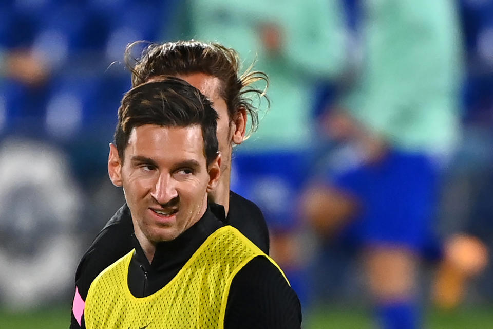 Barcelona's Argentine forward Lionel Messi and Barcelona's French midfielder Antoine Griezmann (BEHIND) warm up before the Spanish League football match between Getafe and Barcelona at the Coliseum Alfonso Perez stadium in Getafe, south of Madrid, on October 17, 2020. (Photo by GABRIEL BOUYS / AFP) (Photo by GABRIEL BOUYS/AFP via Getty Images)