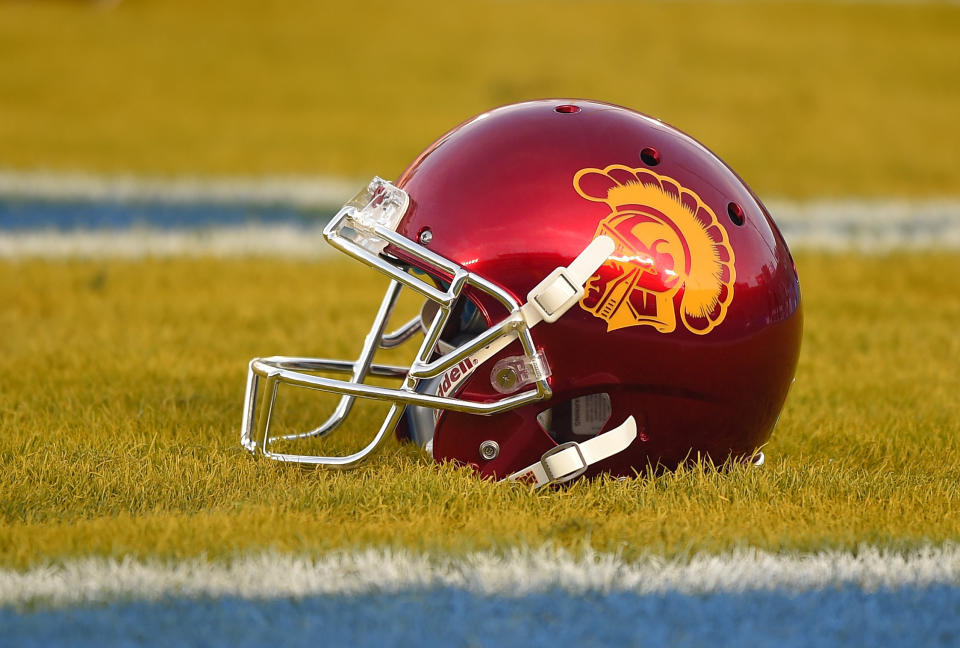 FILE - A Southern California helmet sits in the end zone prior to an NCAA college football game against UCLA, Saturday, Nov. 22, 2014, in Pasadena, Calif. A Los Angeles jury could be the first in the U.S. to decide whether the NCAA failed to protect college football players from repeated blows to the head that cause serious brain injuries. Opening statements are scheduled Thursday, Oct. 20, 2022, in the case of a former University of Southern California linebacker who had significant brain damage when he died at age 49. (AP Photo/Mark J. Terrill, File)