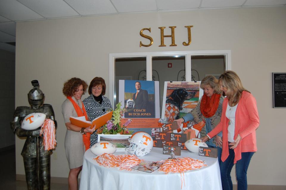 Ann Keyl, Jeanie Sopcak, Anne Goethals and Kelley Whitaker (left to right) work on the table decorations for the annual scholarship banquet featuring Coach Butch Jones of the University of Tennessee, to benefit Sacred Heart of Jesus High School.