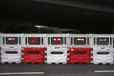 Red cross signs are seen on road blocks used by protesters to set up a makeshift first aid station at the financial Central district in Hong Kong September 30, 2014. REUTERS/Bobby Yip